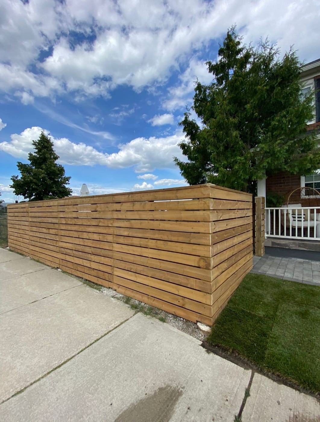 New horizontal cedar privacy fence along a corner lot
